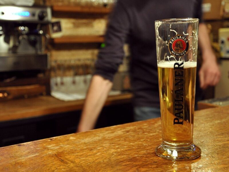 photo of a beer half full on a bar