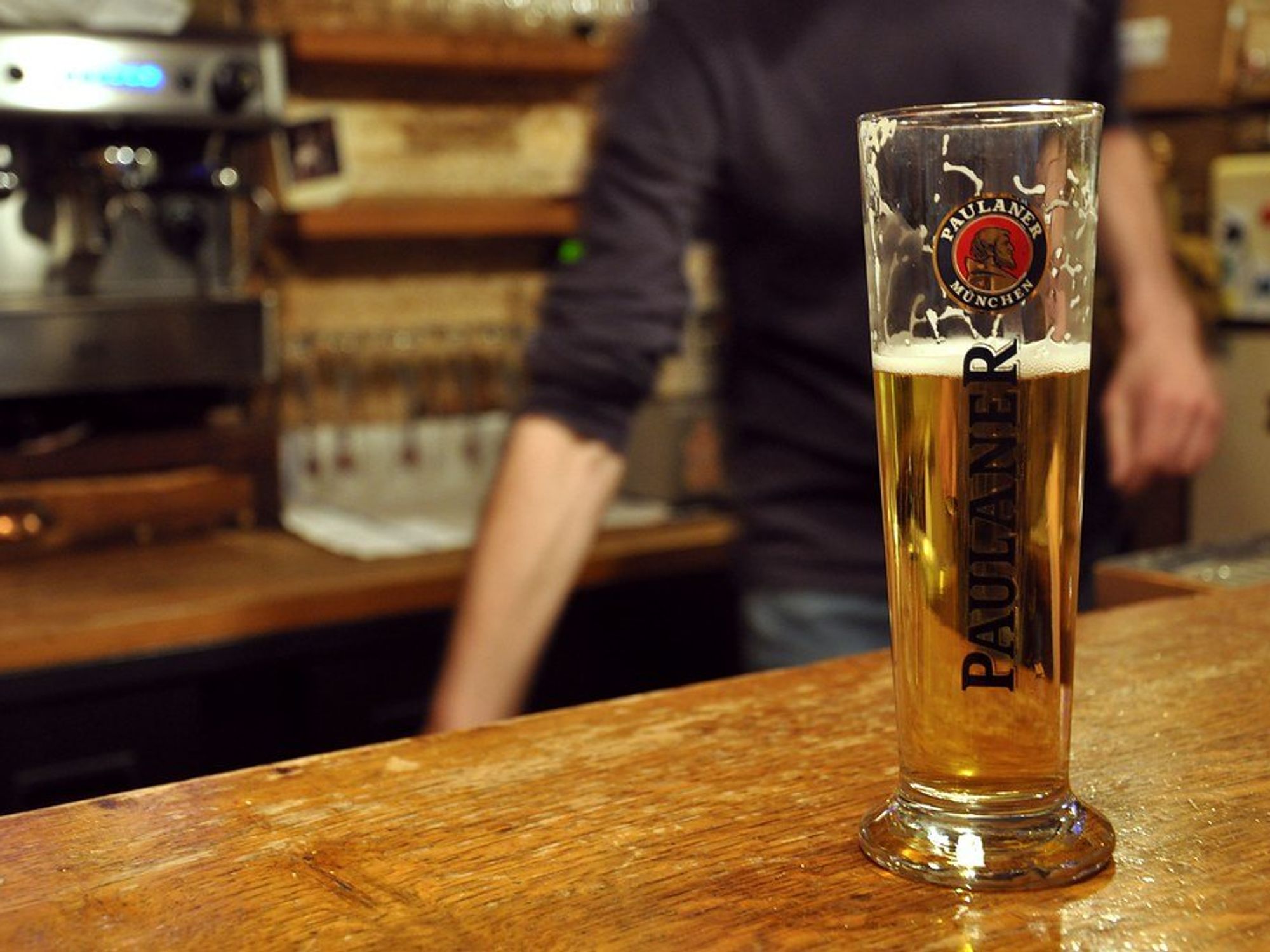 photo of a beer half full on a bar