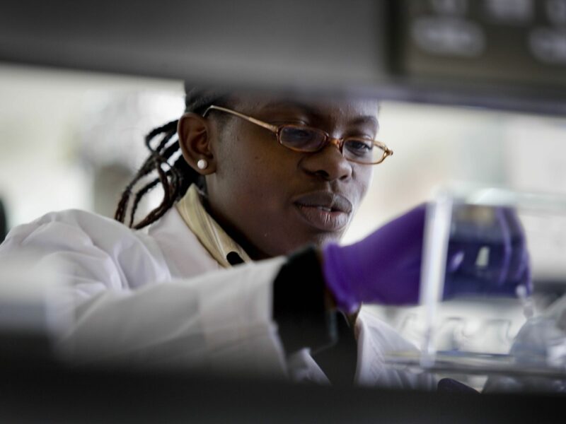 Photo of a Black researcher working in a lab