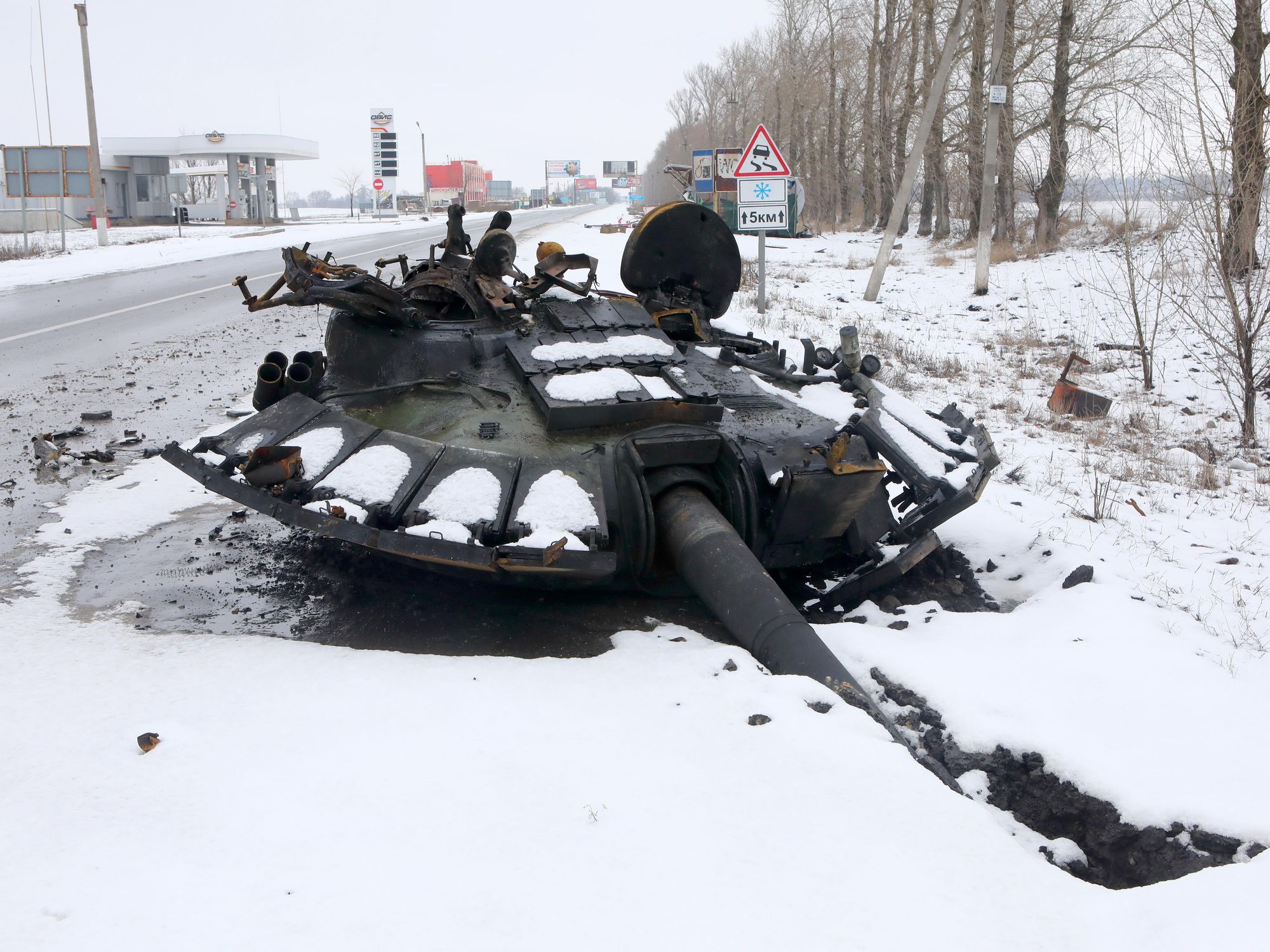 photo of a blown-up tank in snow