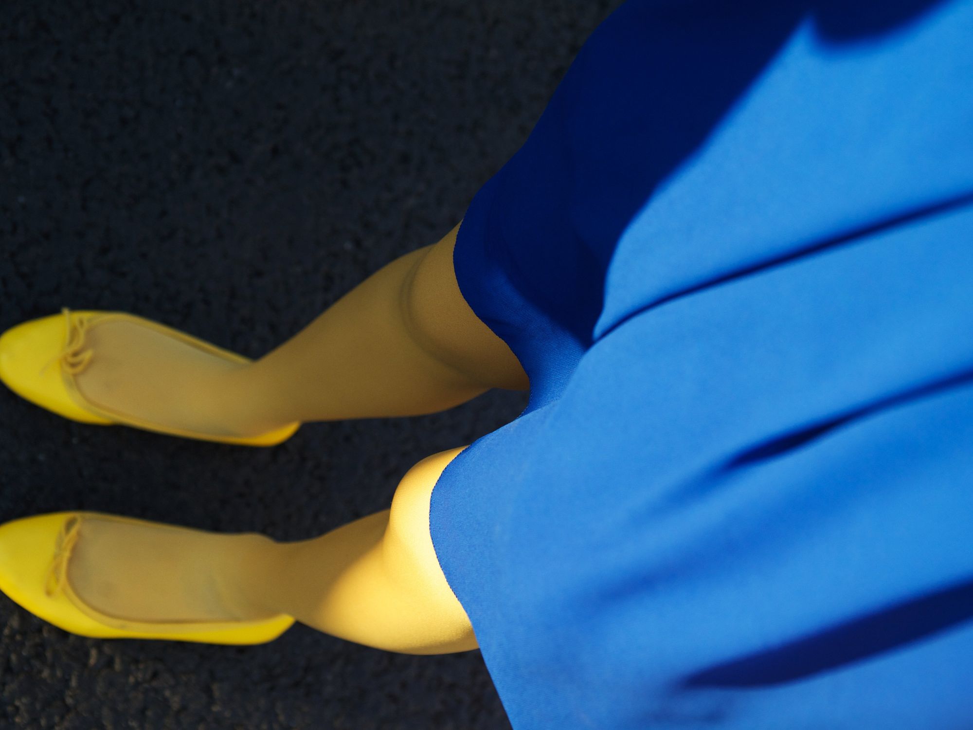 Photo of a blue skirt, yellow tights and shoes in the colours of the Ukraine flag
