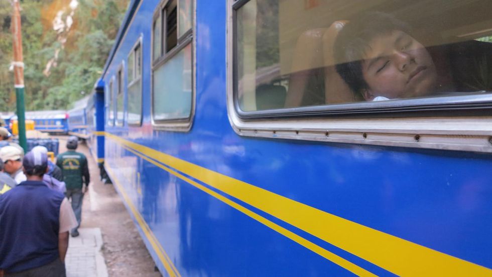 photo of a boy asleep inside a train