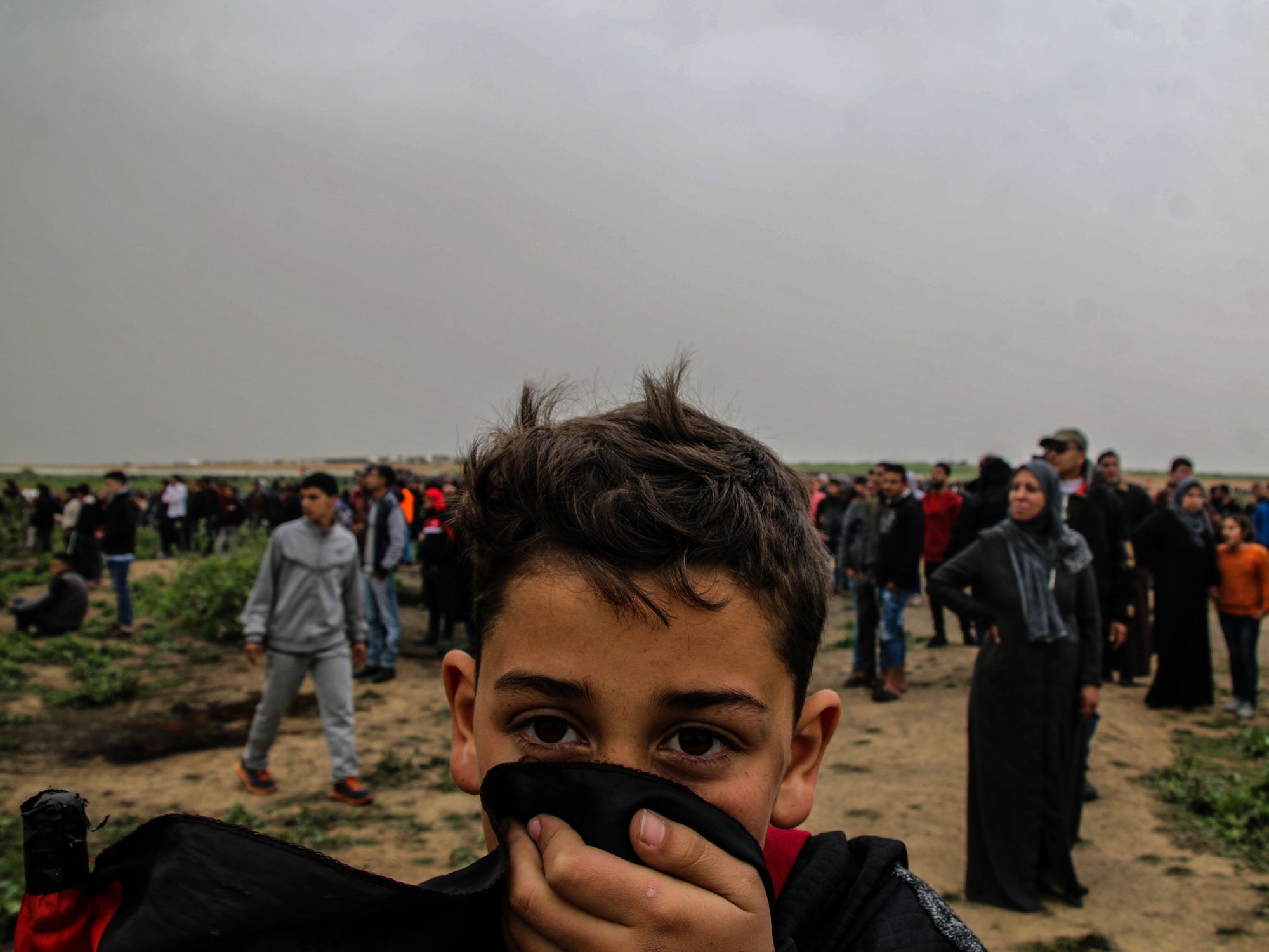 photo of a boy covering his face