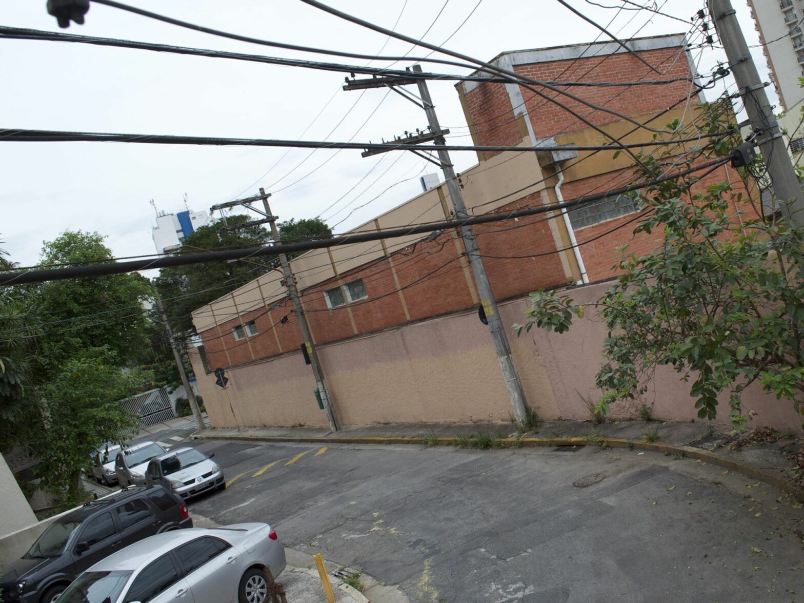photo of a brown building and power lines