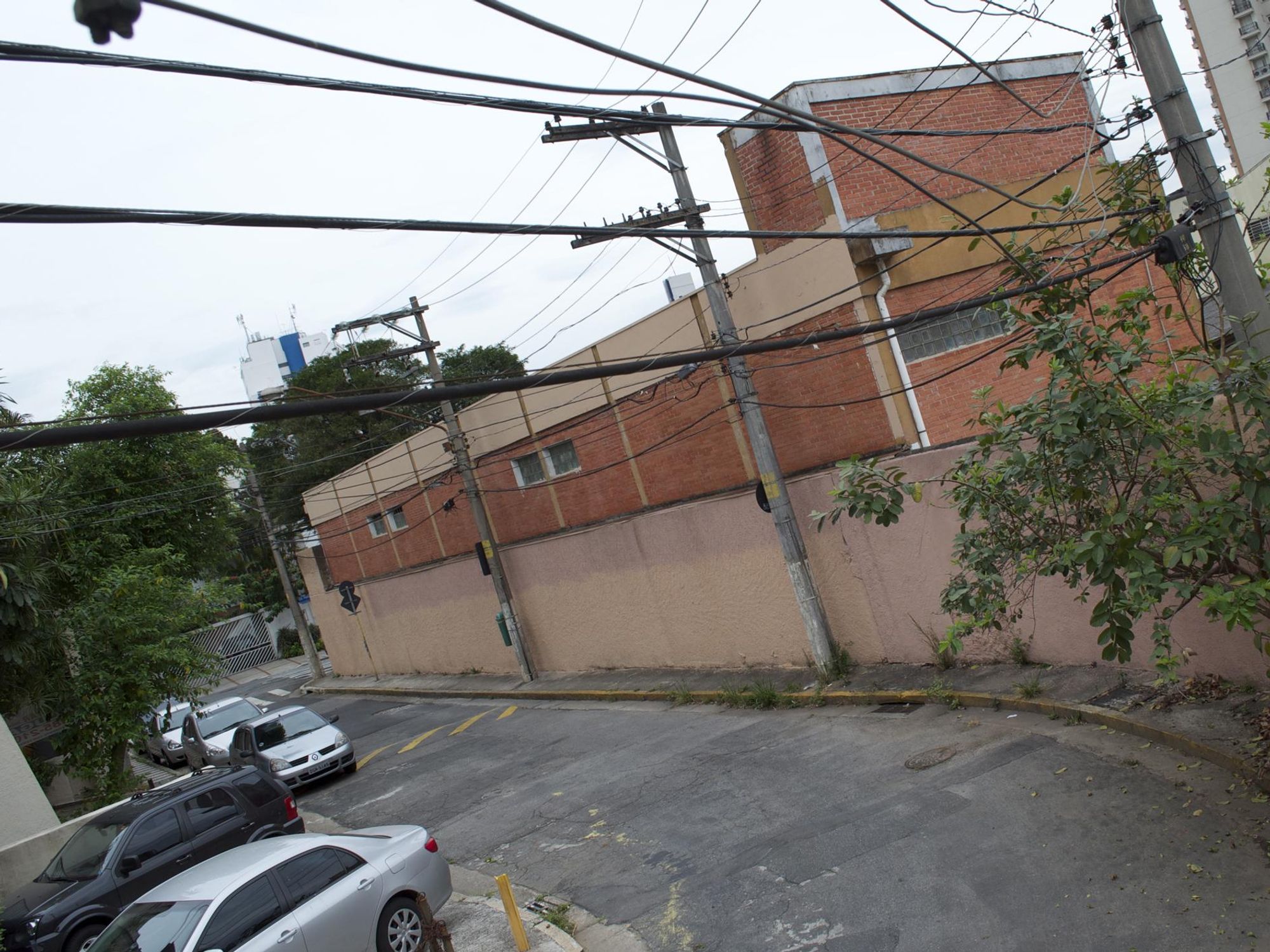photo of a brown building and power lines