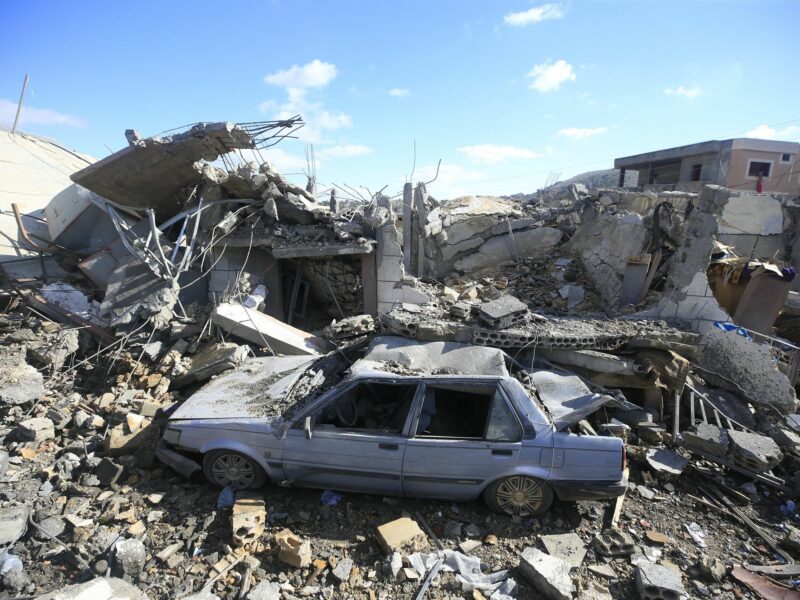 photo of a building and car destroyed
