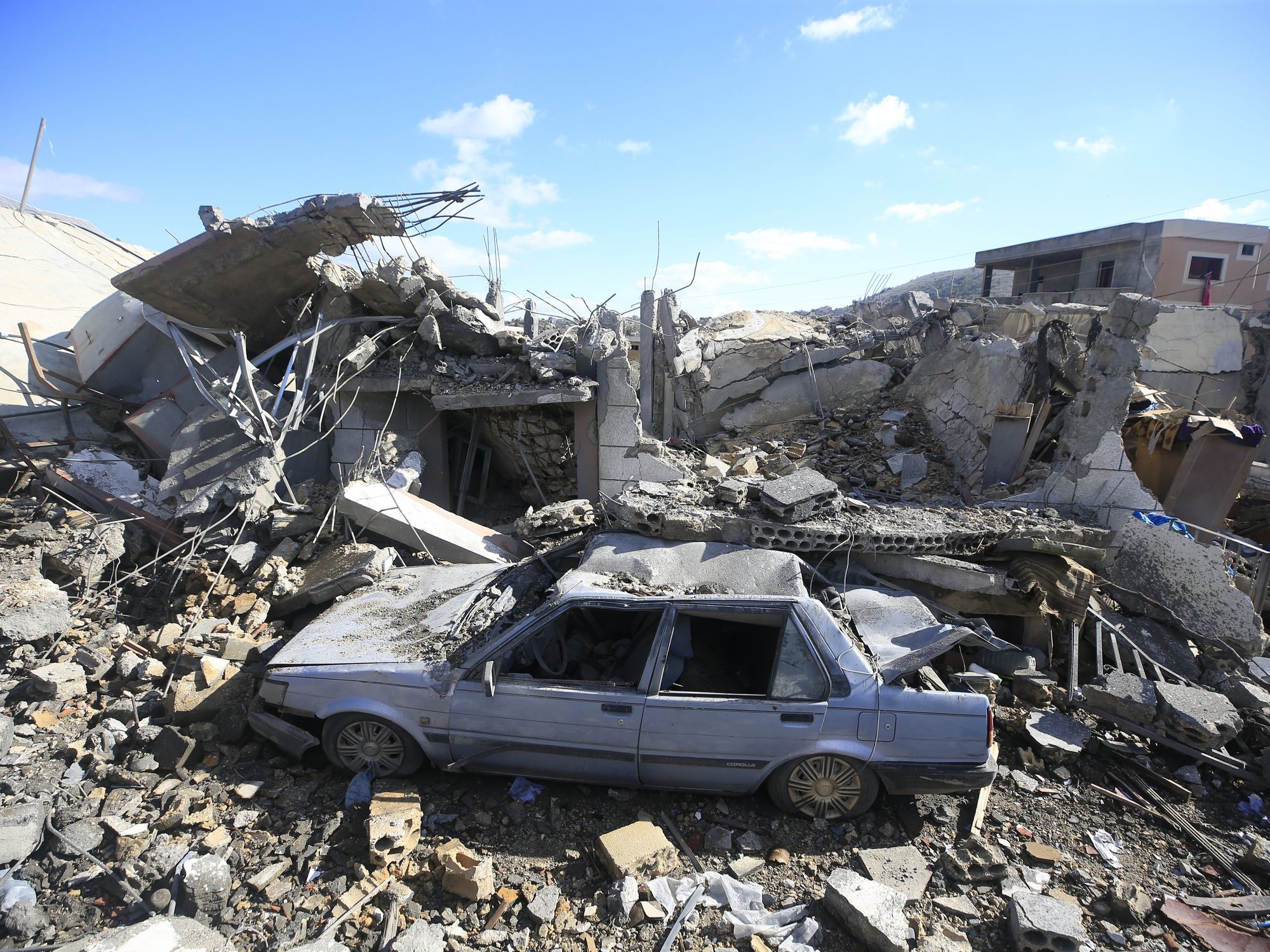 photo of a building and car destroyed