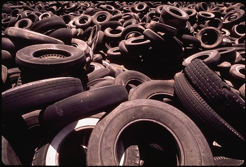 Photo of a bunch of tires in a landfill