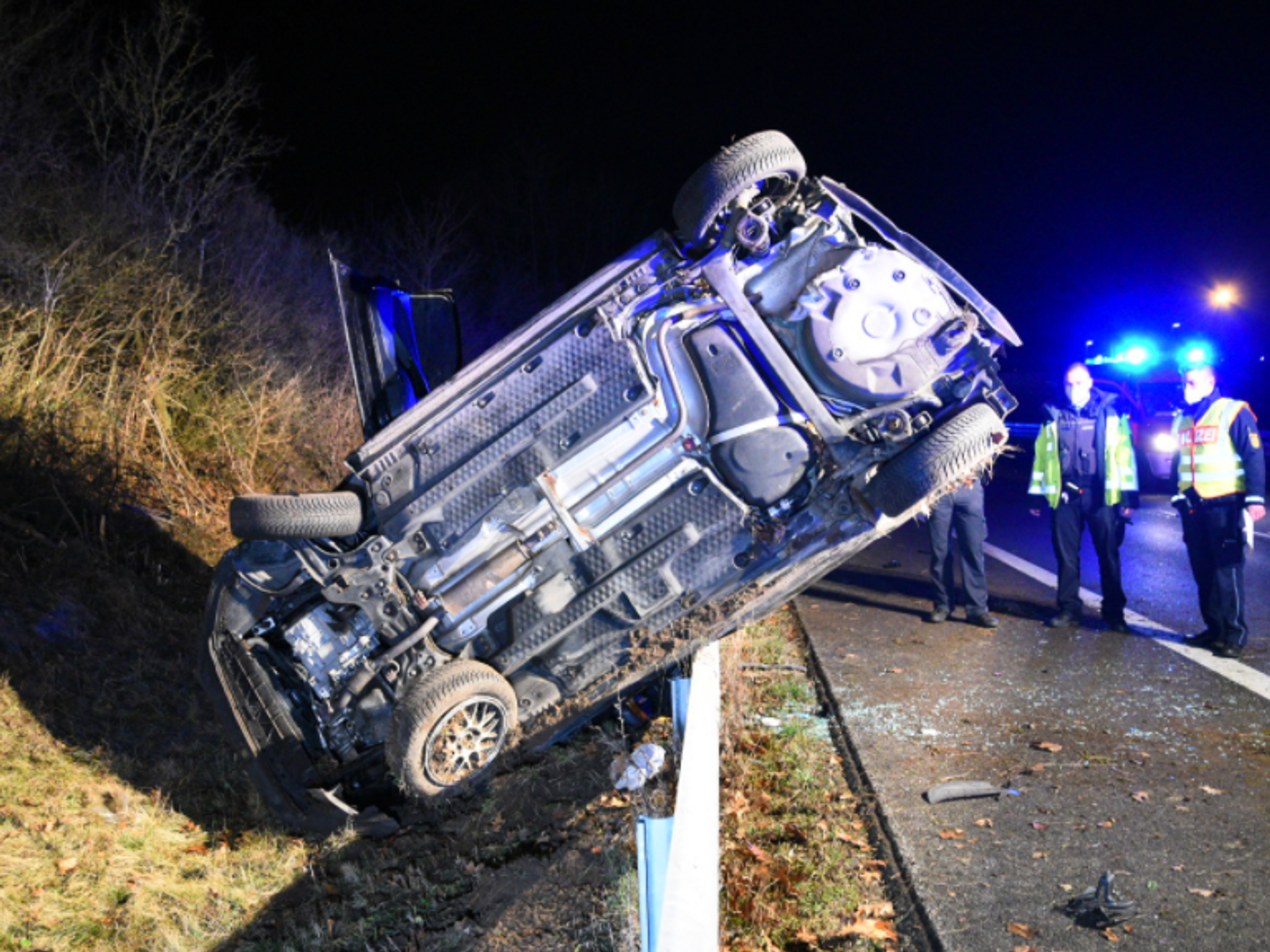 Photo of a car flipped over on the side of the road after a traffic accident in Hockenheim, Germany