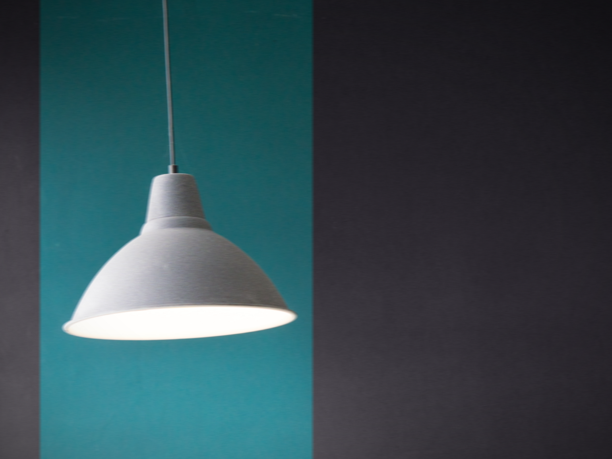 Photo of a ceiling lamp in front of a blue wall