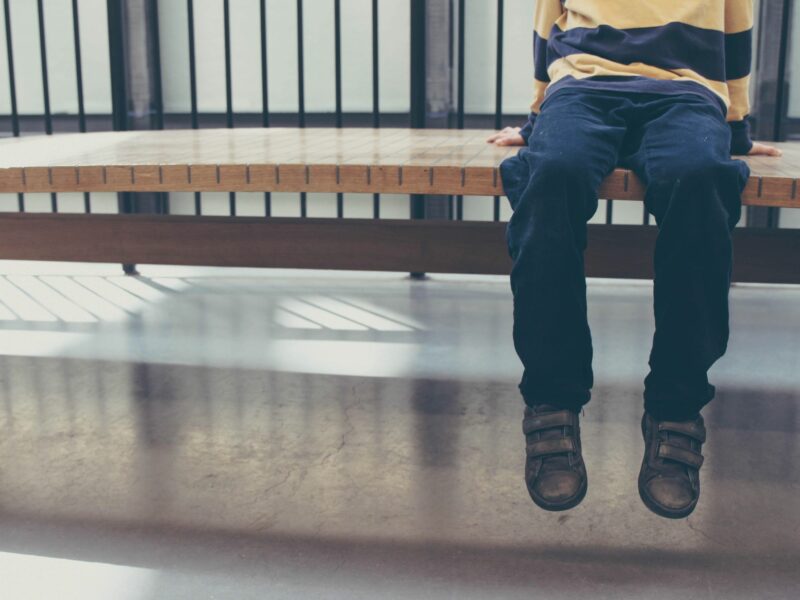 Photo of a child sitting on a bench