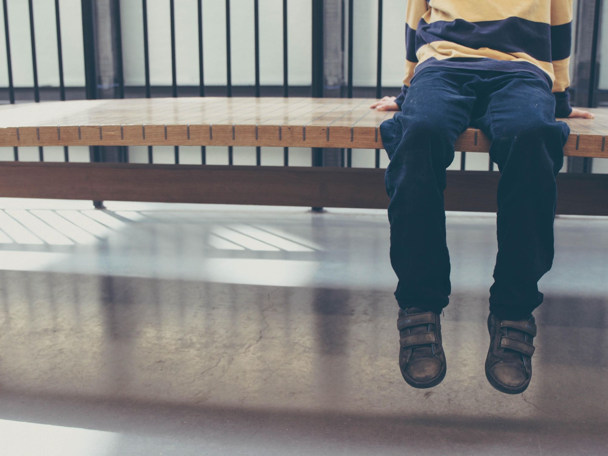 Photo of a child sitting on a bench