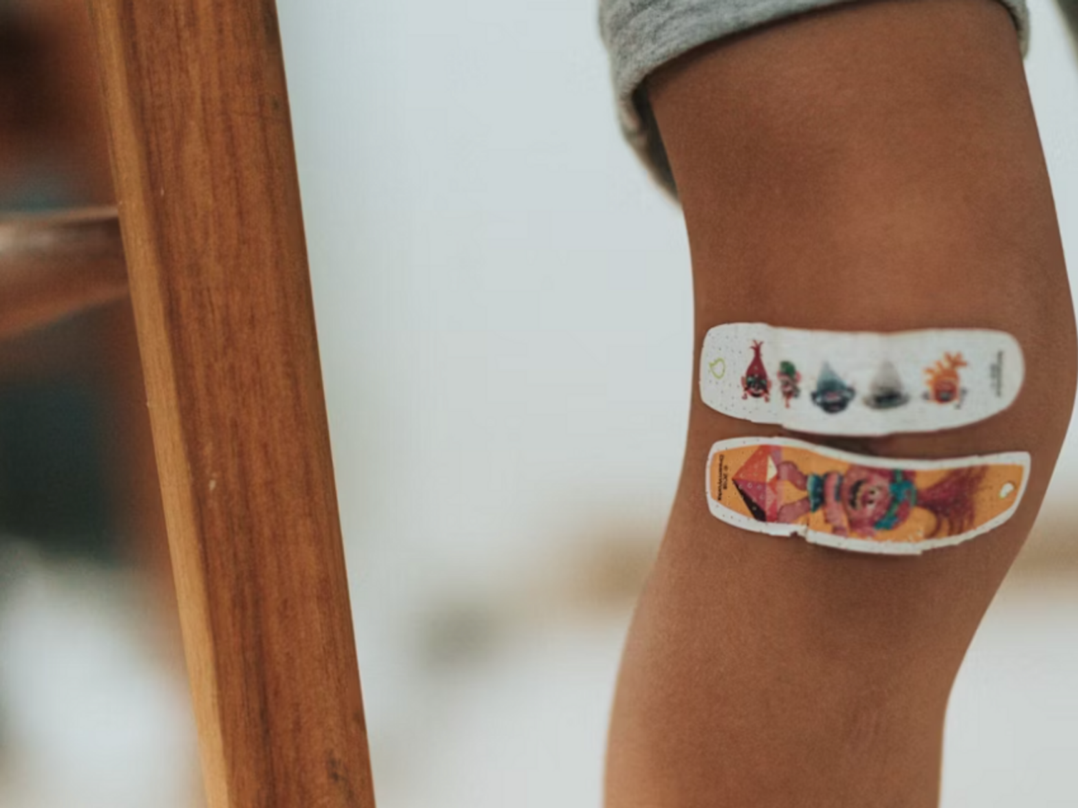 Photo of a child's leg with two band-aids