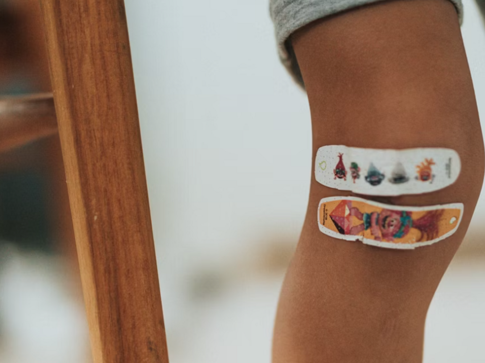 Photo of a child's leg with two band-aids
