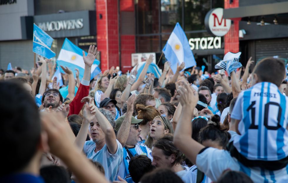 Photo of a crowd celebrating Argentina's victory at the 2022 FIFA World Cup on the streets of Buenos Aires