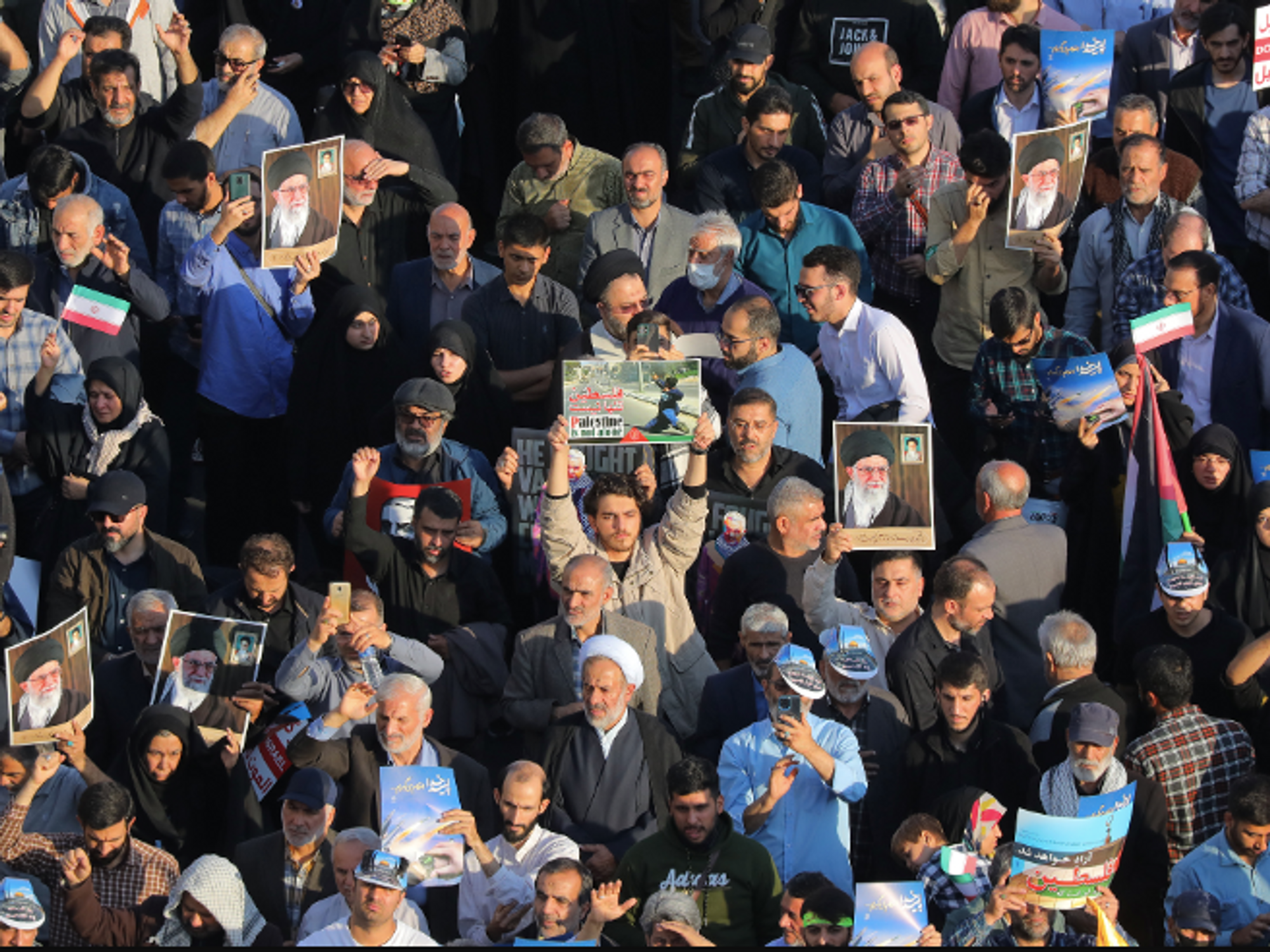 photo of a crowd of people holding signs