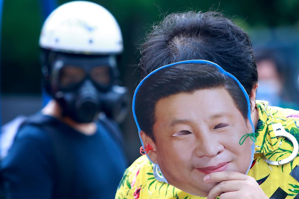 Photo of a demonstrator wearing a mask with the face of Chinese president Xi Jinping in Taipei, Taiwan, on Dec. 10