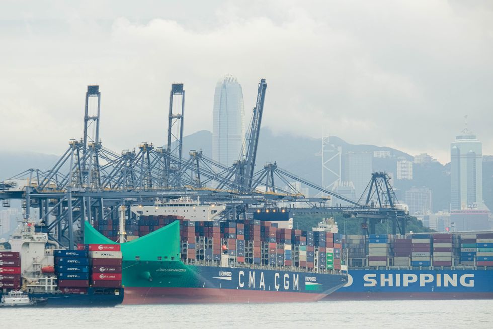 photo of a dock with shipping containers and barges