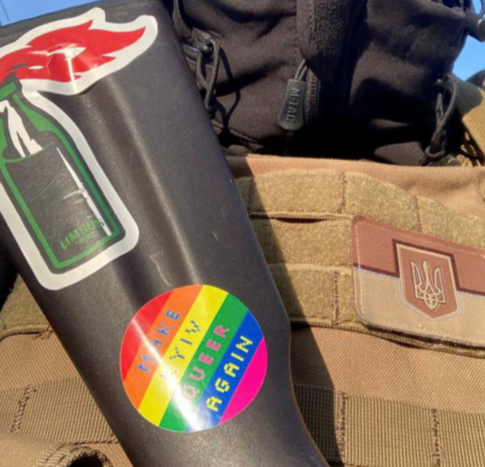 Photo of a ​"Make Kyiv Queer Again" sticker on a rifle