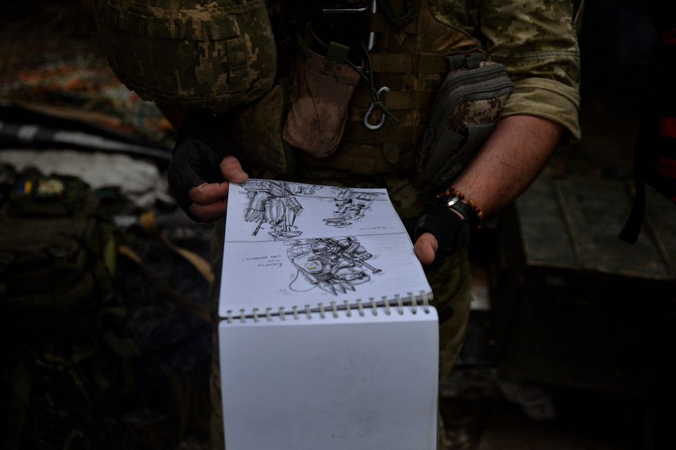 Photo of a ​Ukrainian soldier drawing on the front lines near Kharkiv, Ukraine, on June 15, 2023.