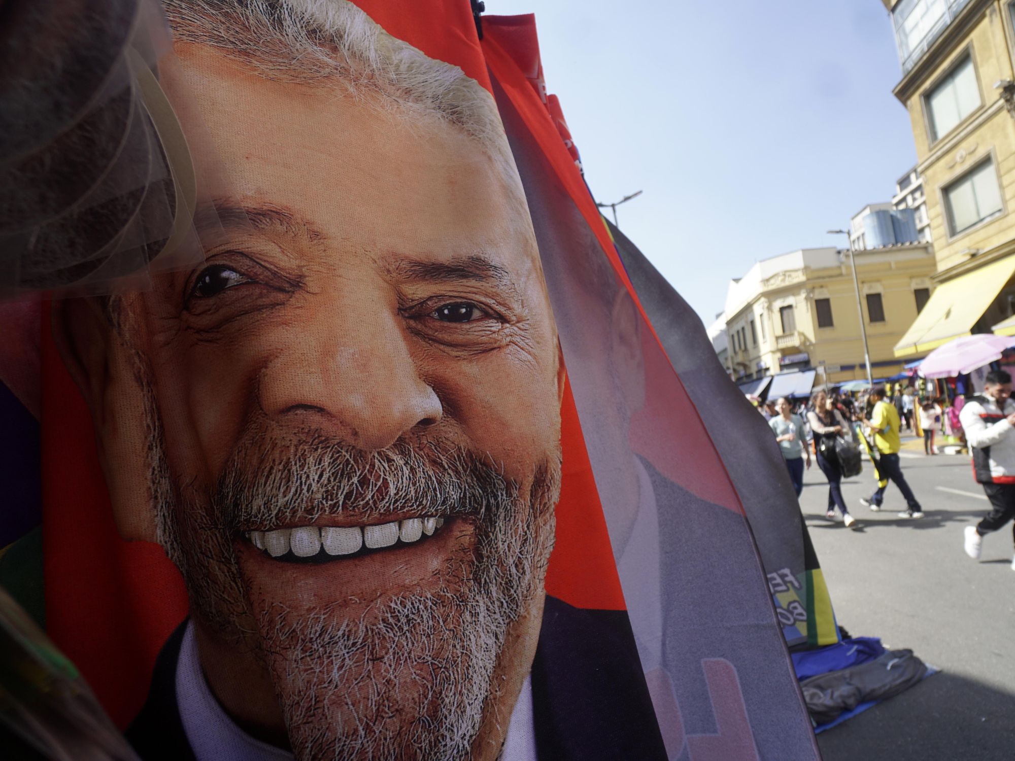 Photo of a fabric banner with presidential candidate Lula's face in a street of Sao Paulo