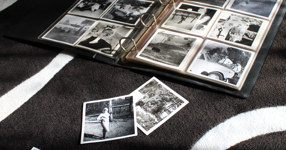 Photo of a family album with black-and-white photographs