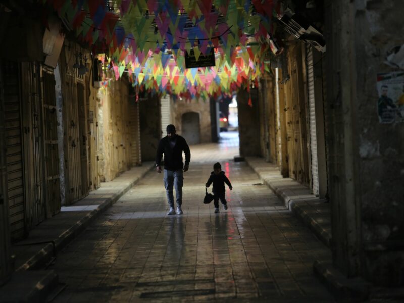 Photo of a father and son walking through the streets of the city of Nablus in Palestine