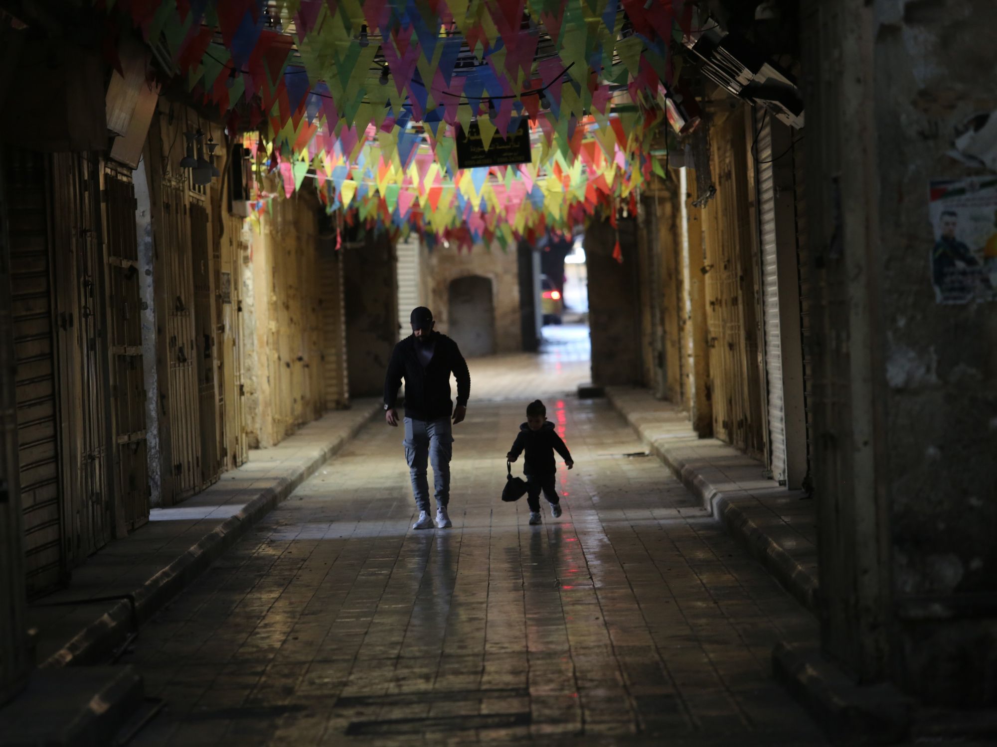 Photo of a father and son walking through the streets of the city of Nablus in Palestine
