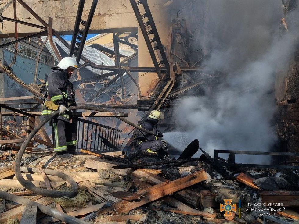 Photo of a fireman near rubble after Russian shelling hit Mykolaiv