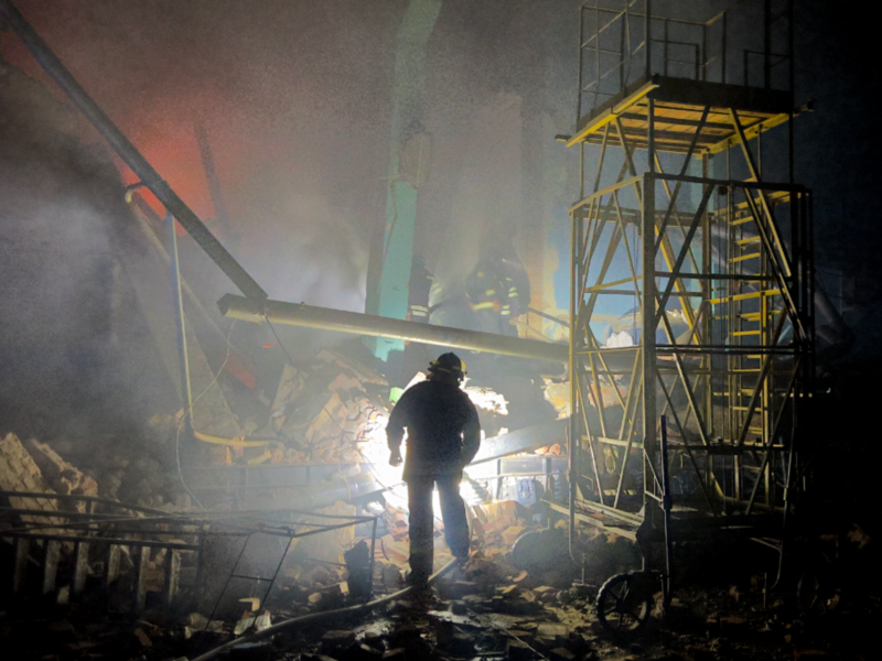 Photo of a fireman walking among rubble after a rocket attack by Russian troops in Kharkiv