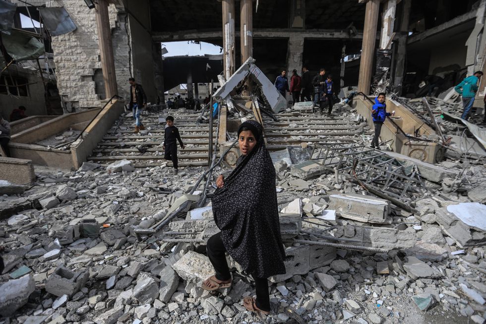 photo of a girl standing in rubble