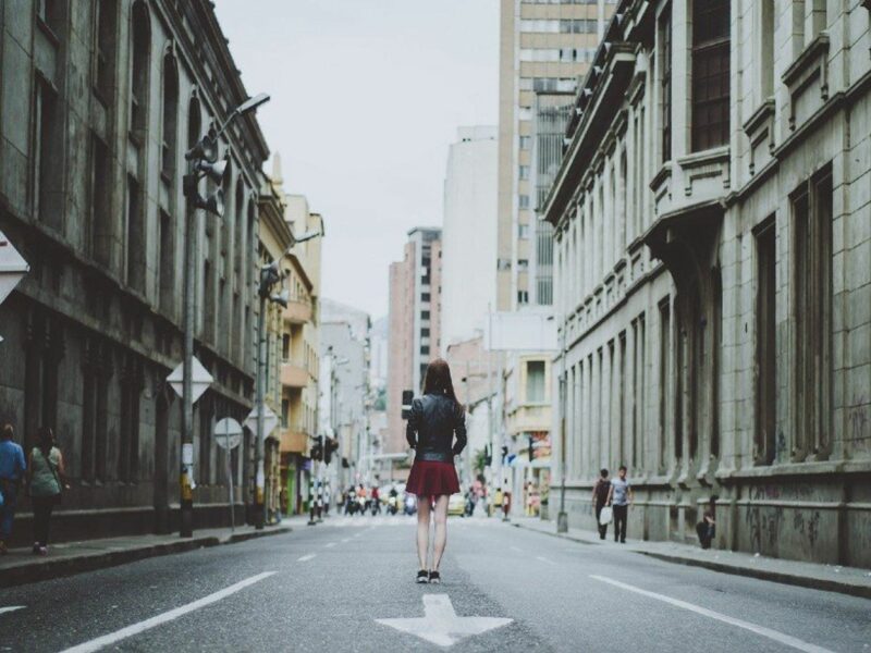 Photo of a girl walking in ​Street scene in Medellín, Colombia