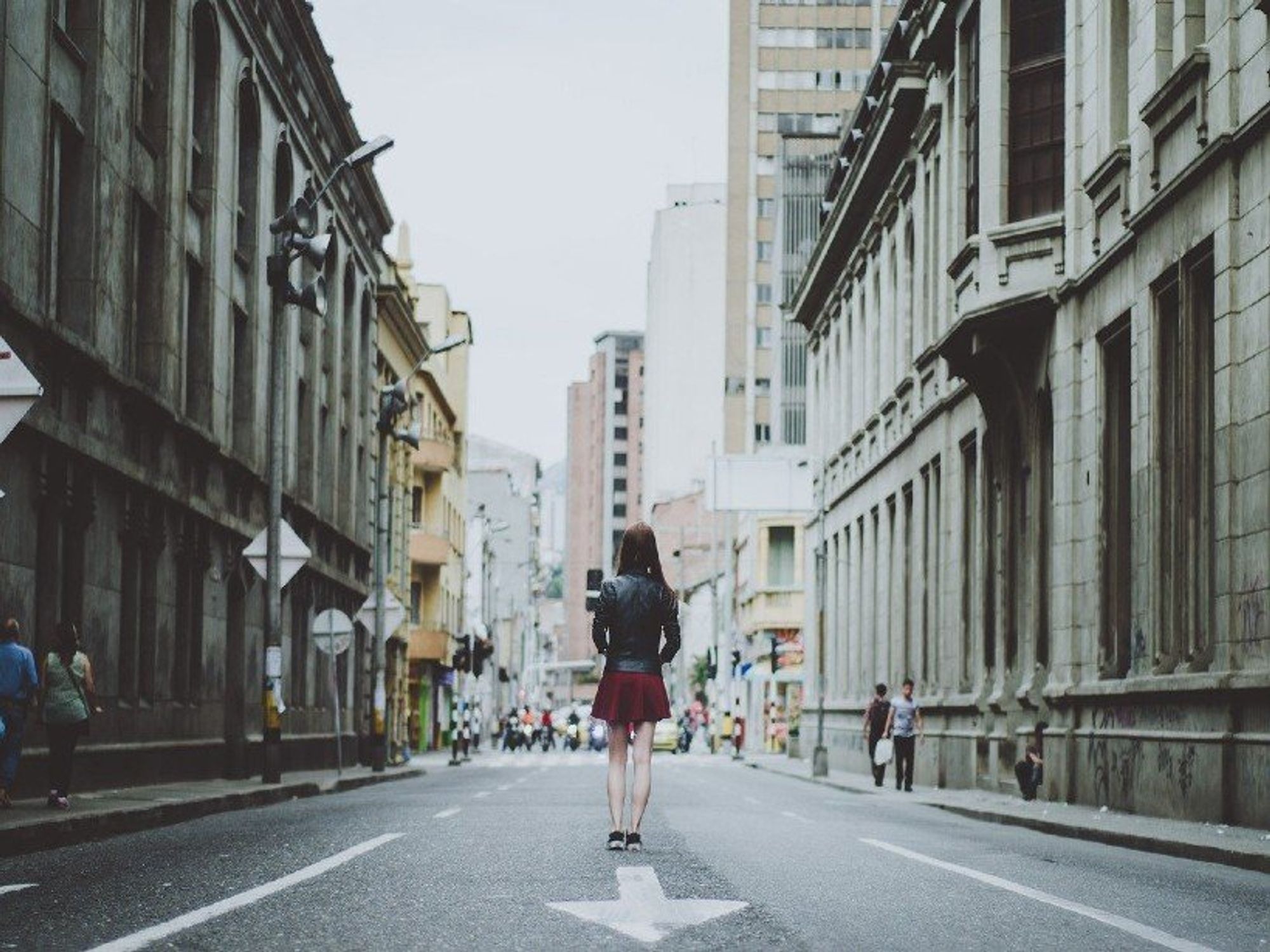 Photo of a girl walking in ​Street scene in Medellín, Colombia