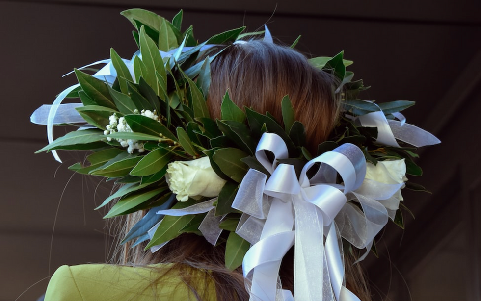 Photo of a girl wearing the traditional laurel wreath worn by students in Italy on their graduation day. ​