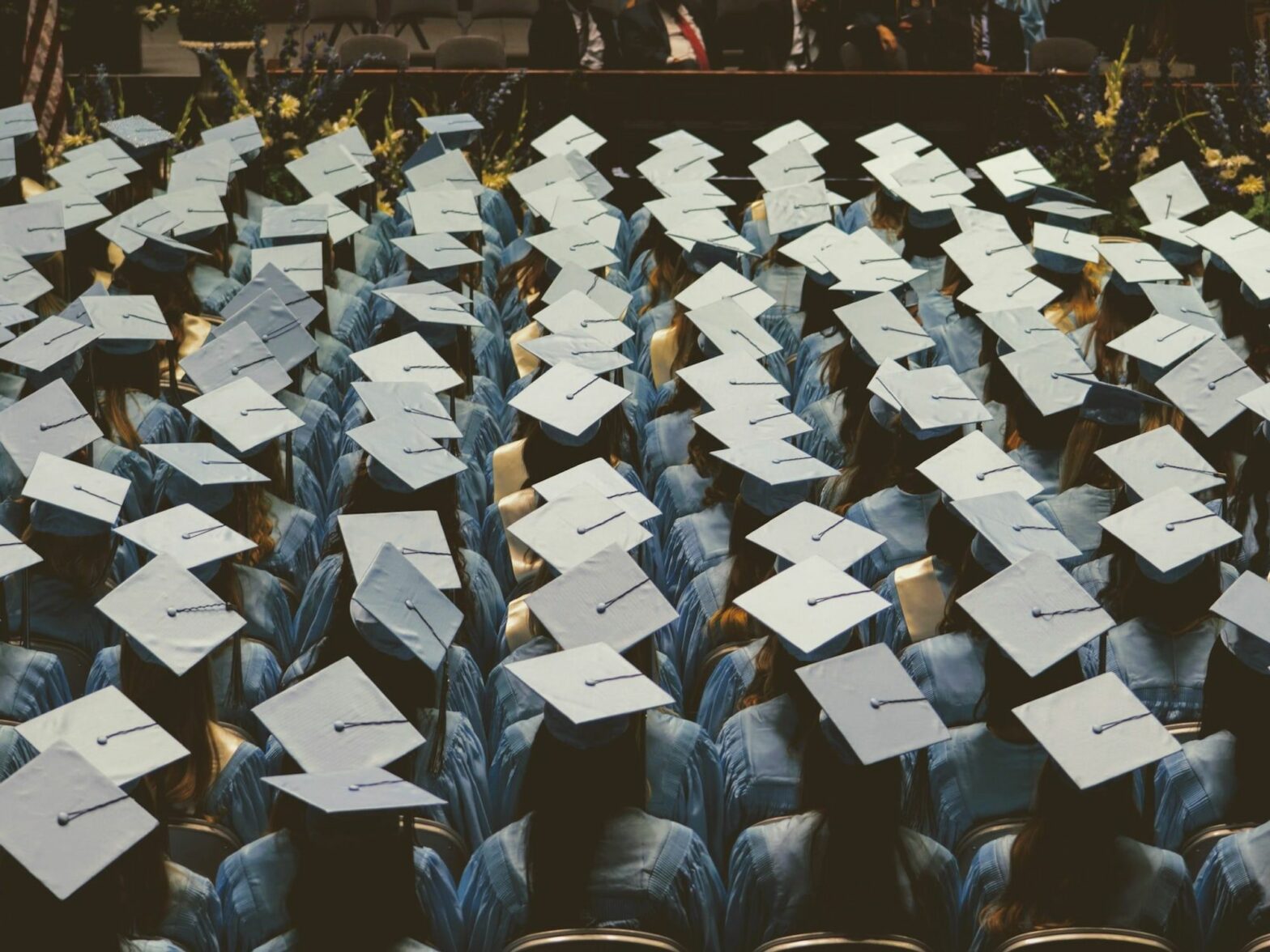 Photo of a graduation ceremony showing the students' hats.