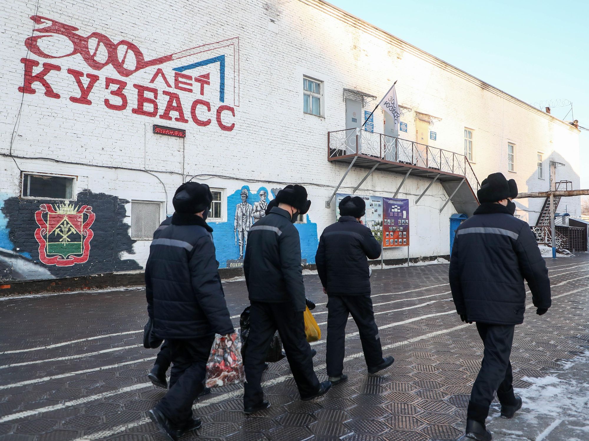 Photo of a group of ​prisoners walking inside a penal colony in Mozzhukha, Russia