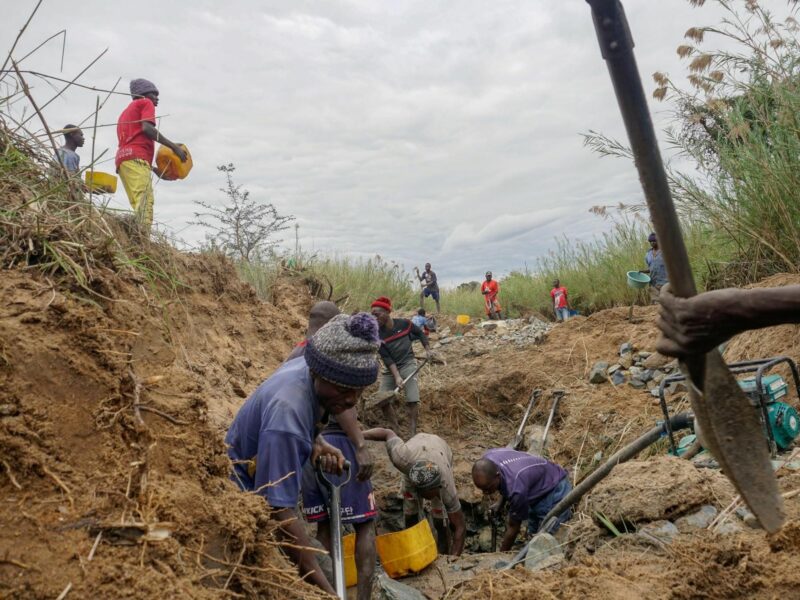 Photo of a group of miners digging for gold.