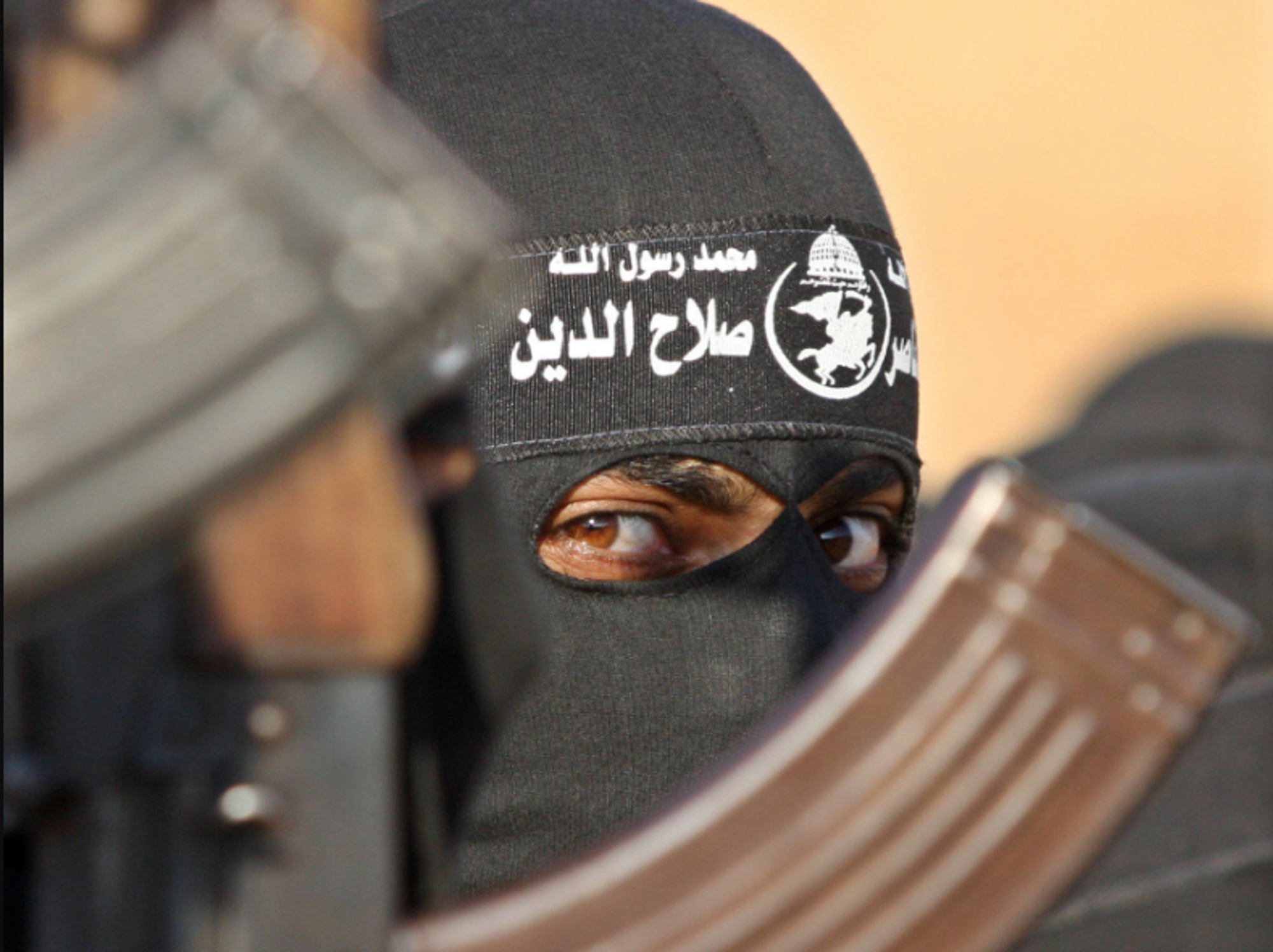 Photo of a Hamas member next to a Russian-made rifle
