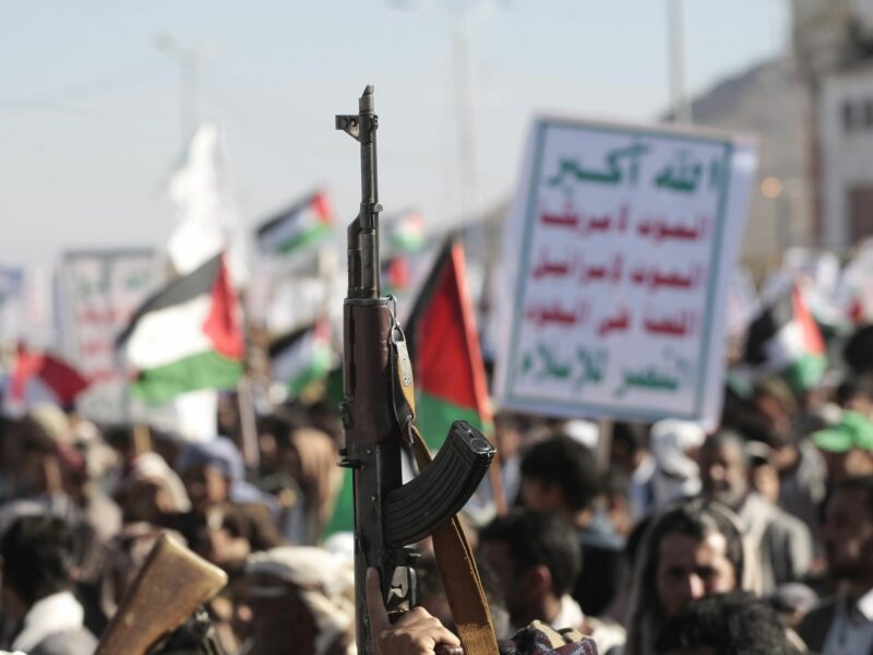 Photo of a hand brandishing a rifle as part of pro-Hamas protests in Sanaa, Yemen, on Jan. 26