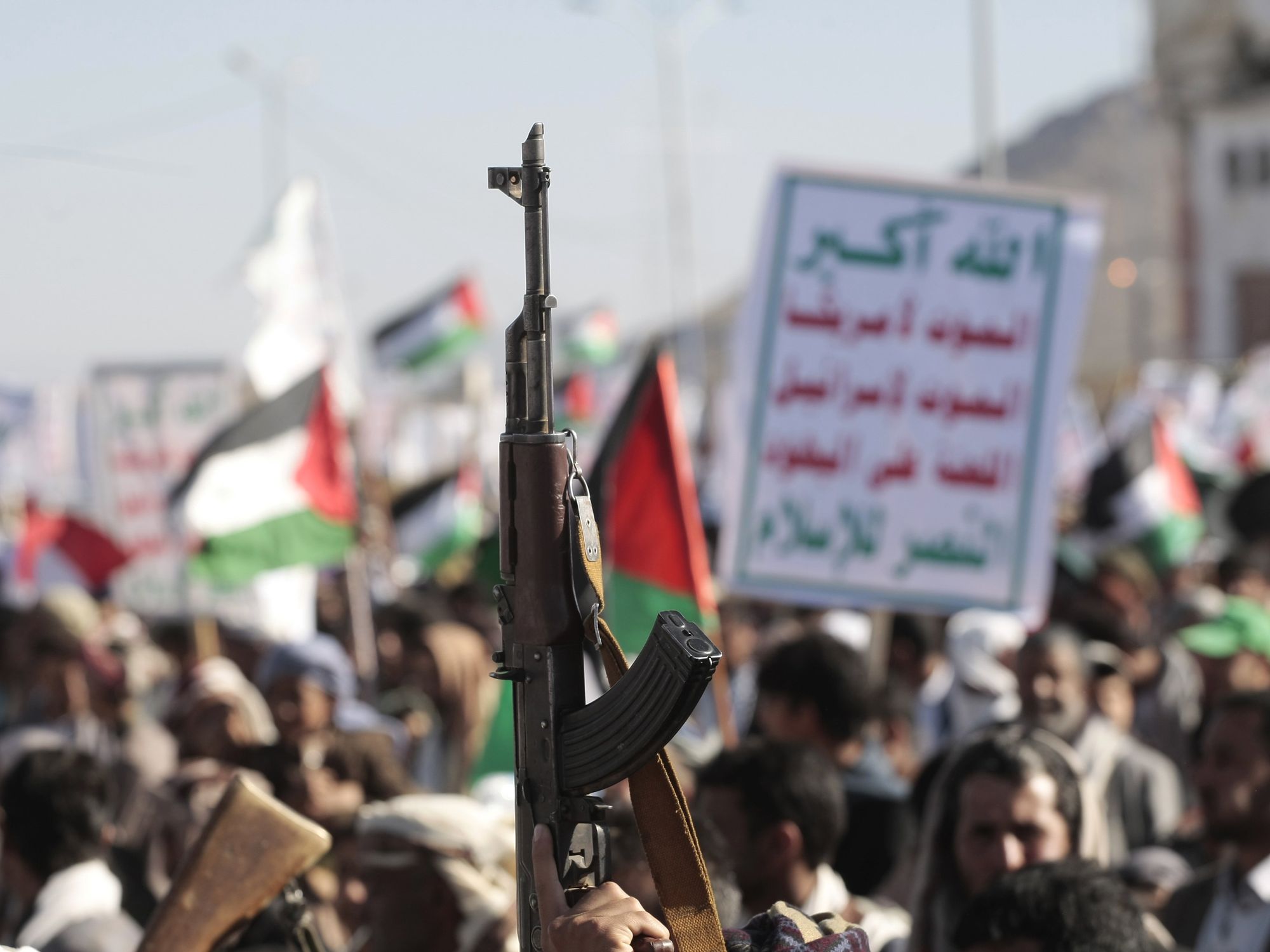 Photo of a hand brandishing a rifle as part of pro-Hamas protests in Sanaa, Yemen, on Jan. 26