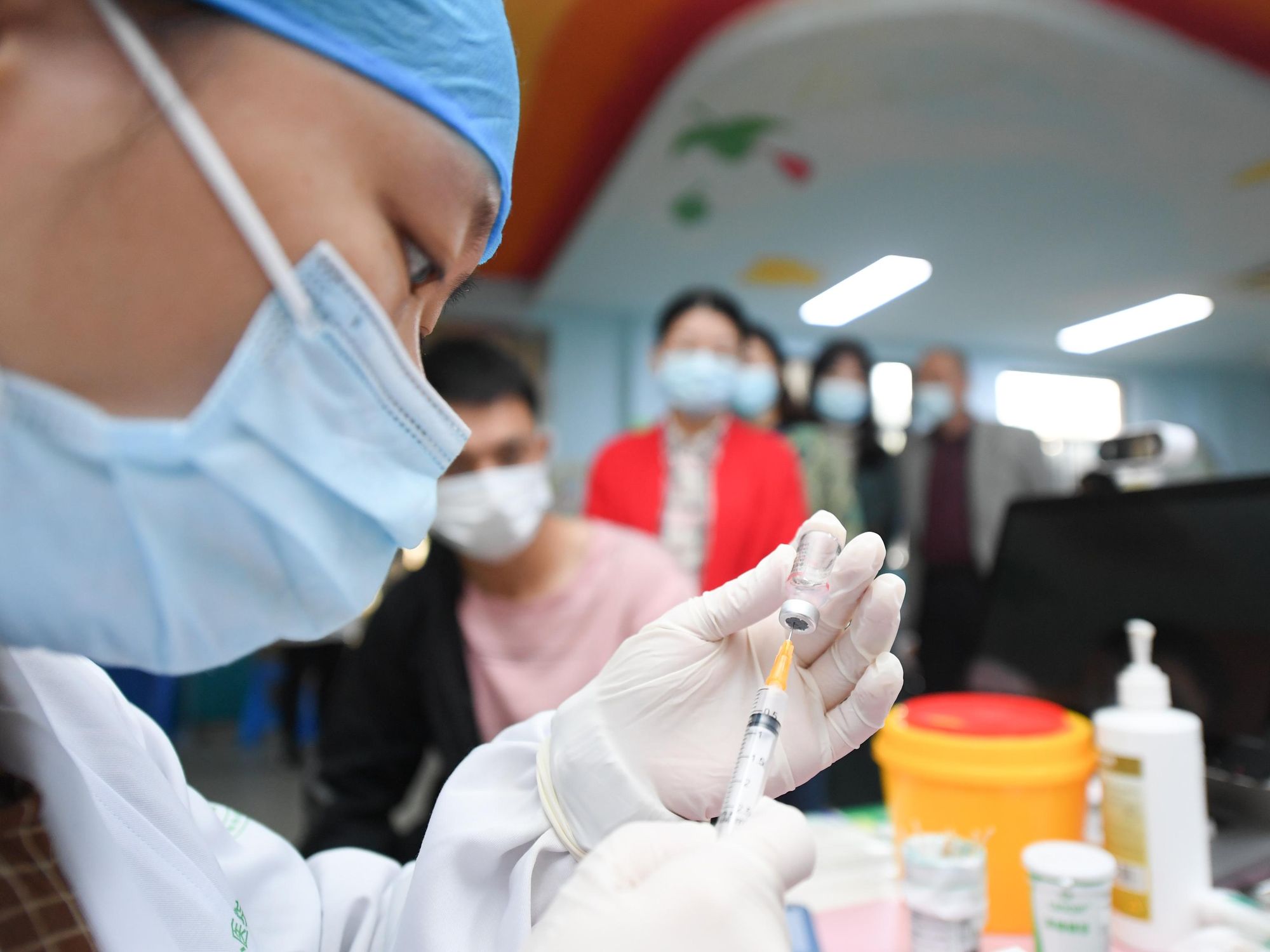 Photo of a health worker preparing a COVID-19 vaccine booster shot at a community medical service center in Huzhou, in eastern China's Zhejiang Province. More than 2.25 billion doses of COVID-19 vaccines had been administered on the Chinese mainland, the most of any country.