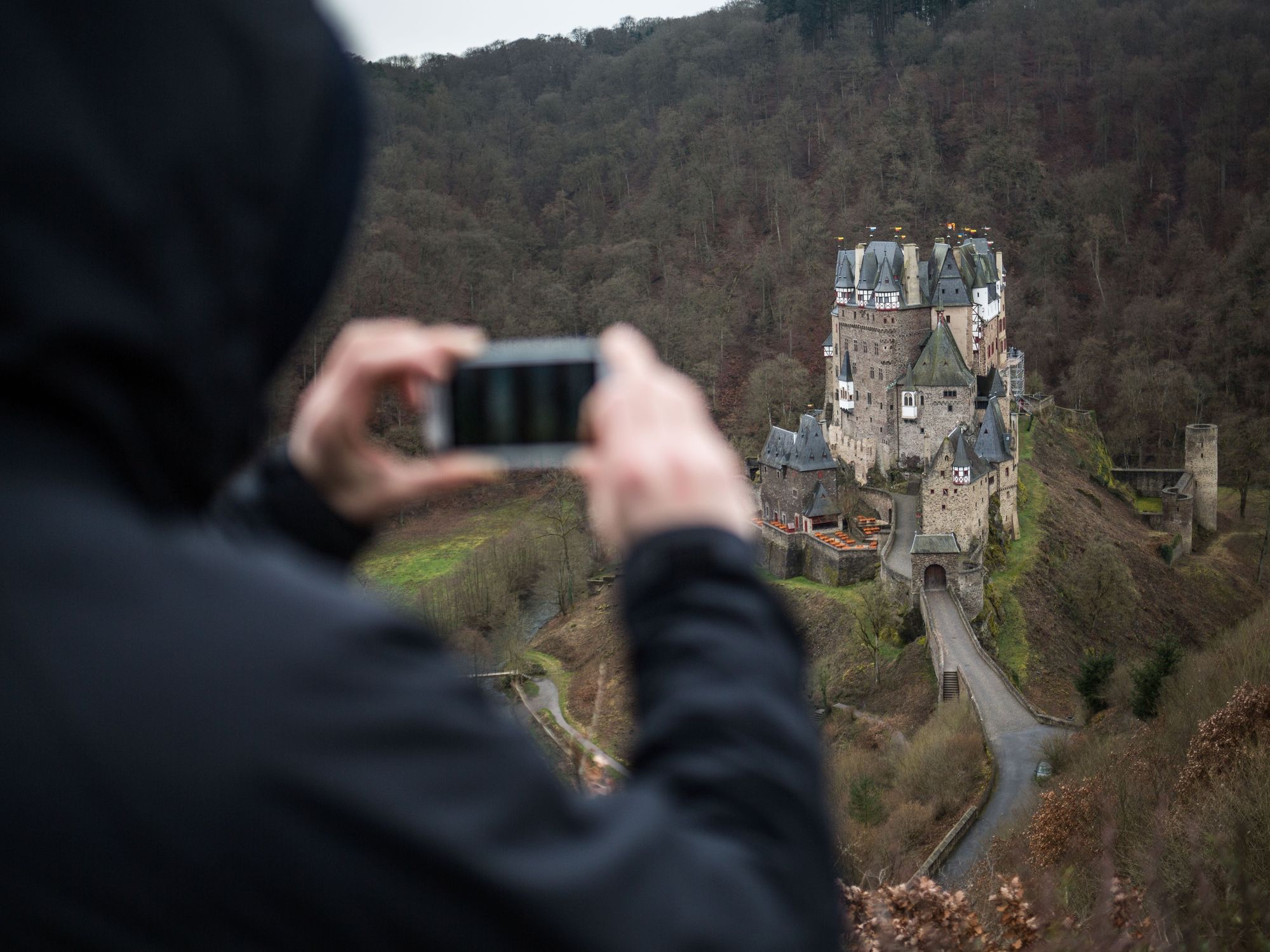 Photo of a hiker taking a picture of Eltz Castle near Wierschem, Germany, 04 March 2016.