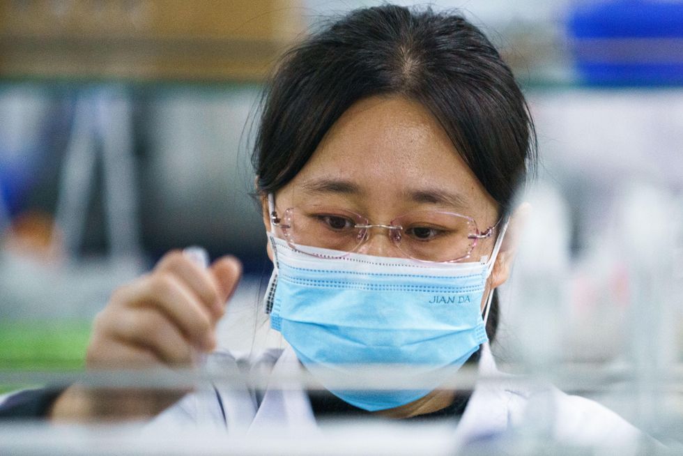 photo of a lab technician with a mask