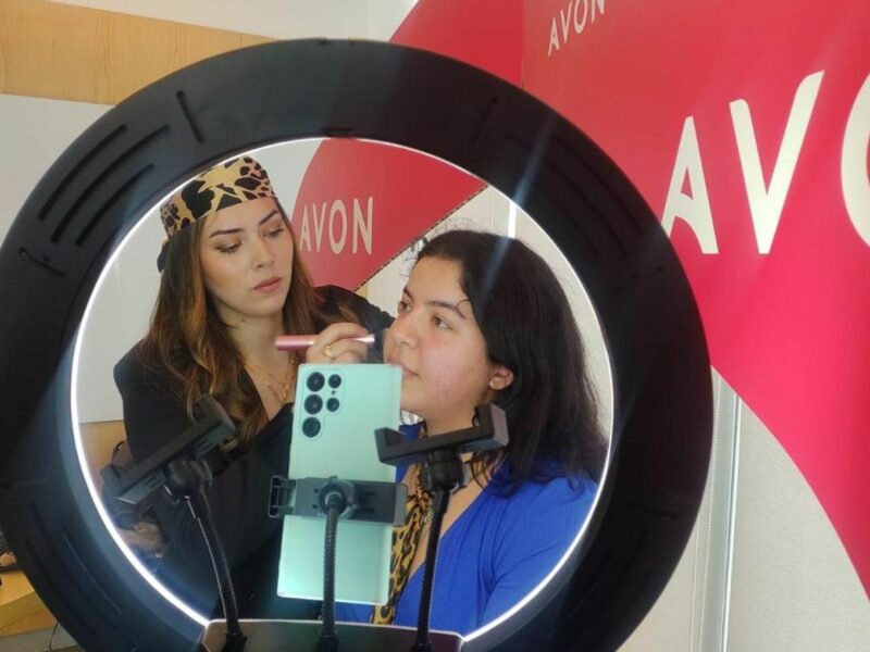 Photo of a make up artist applying make-up on another woman