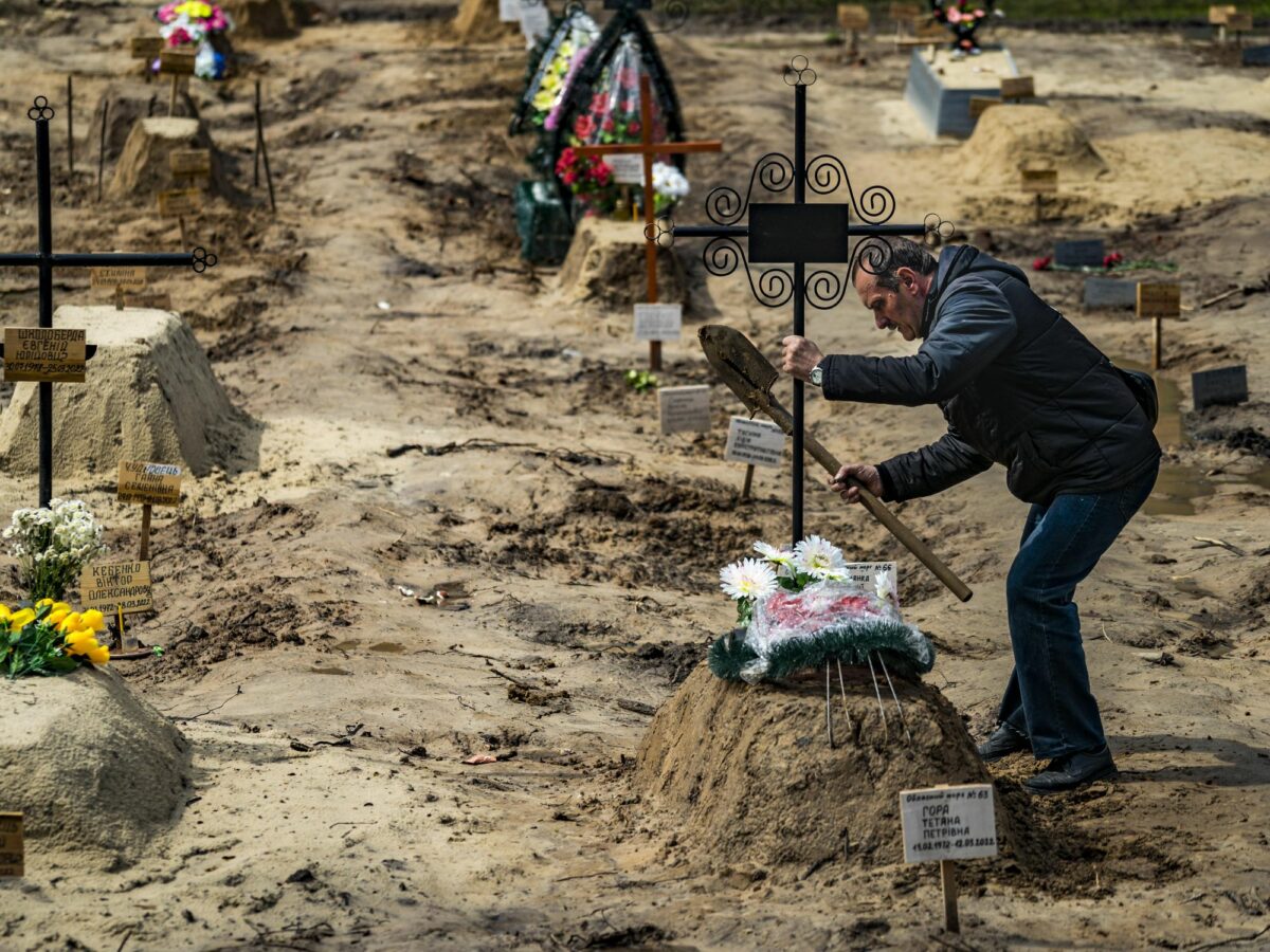 Photo of a man burying a relative