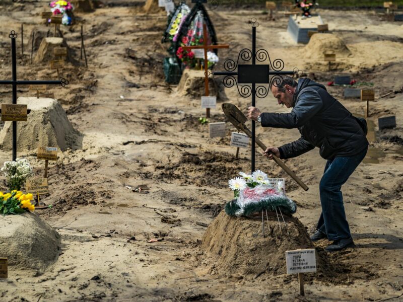 Photo of a man burying a relative