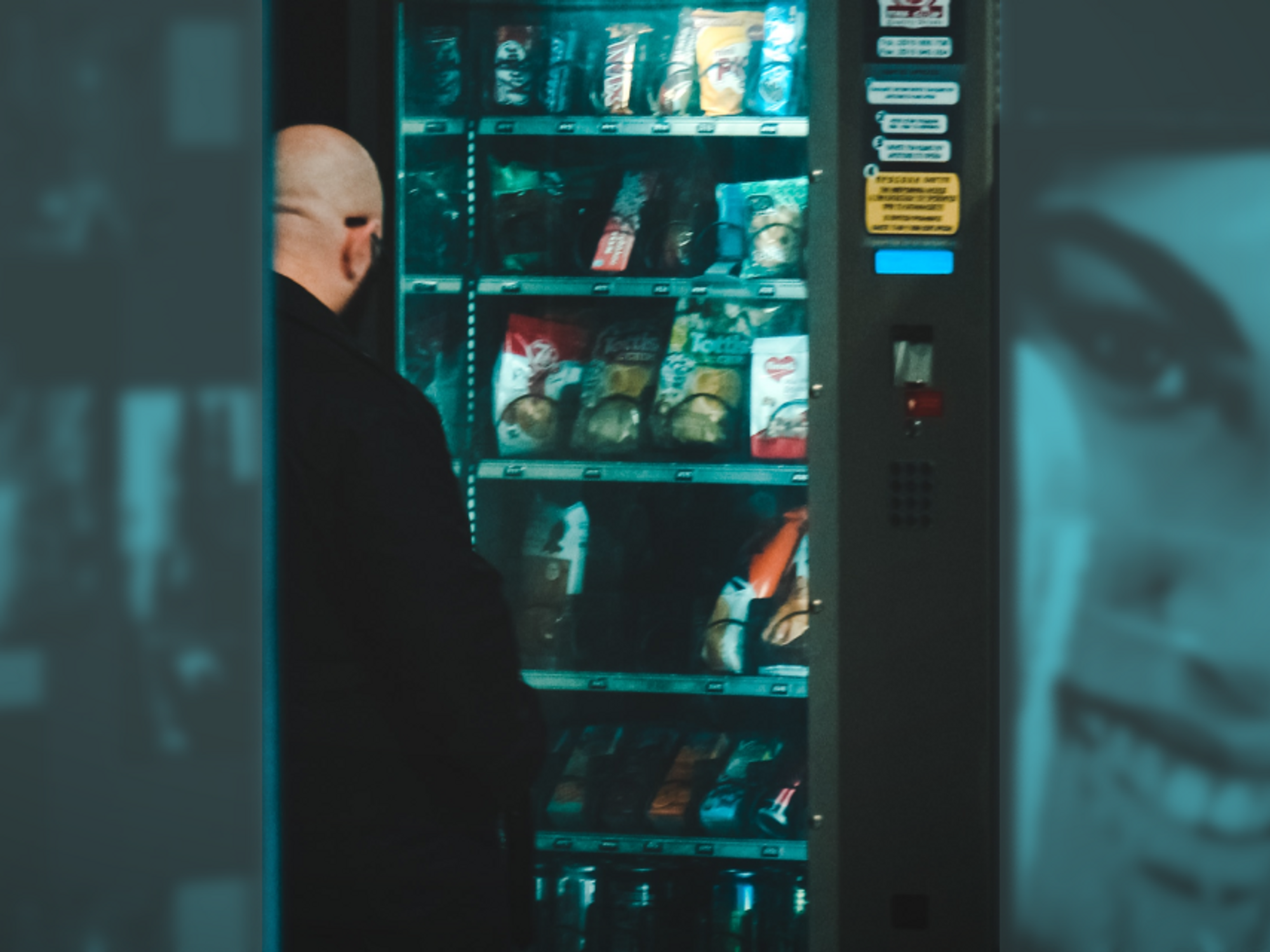 Photo of a man buying a snack at a vending machine