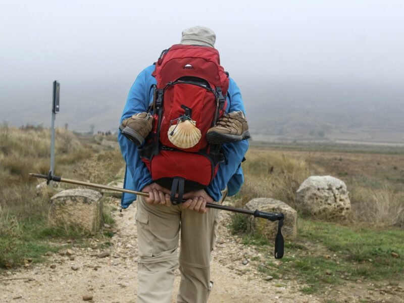 Photo of a man carrying a backpack with the Camino shell
