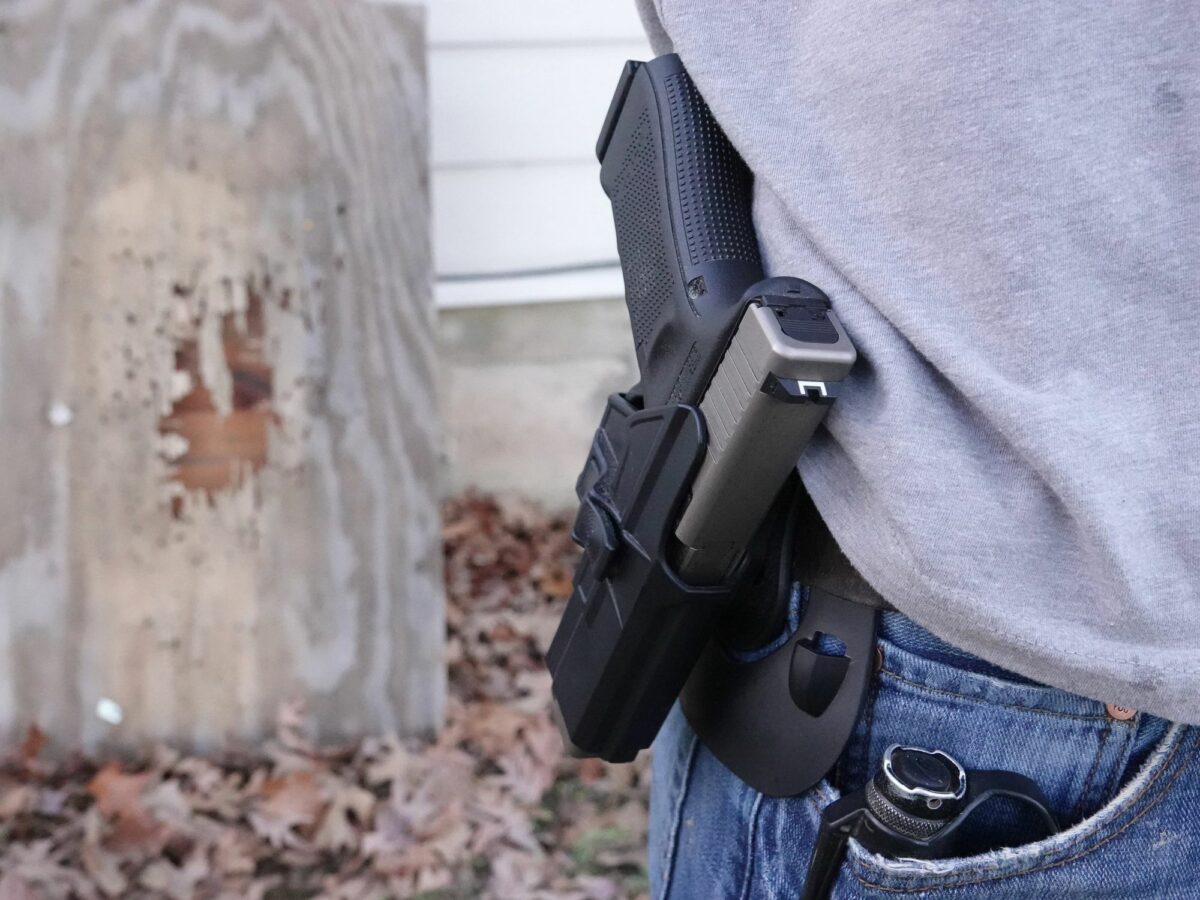 Photo of a man carrying a handgun in a holster