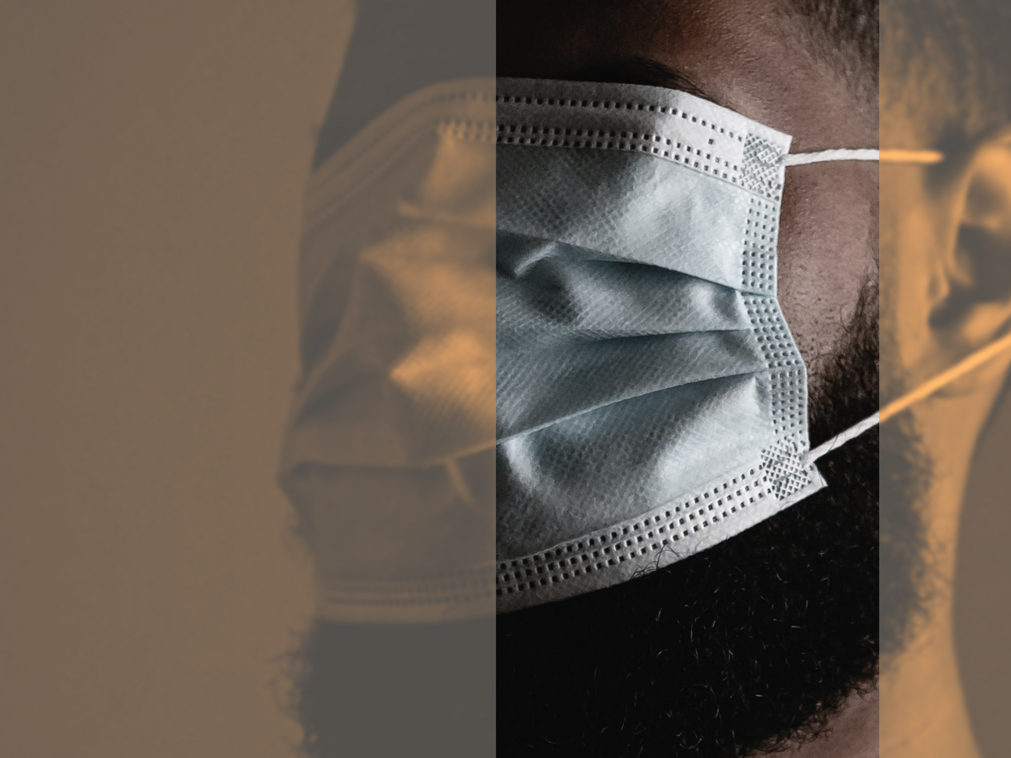 Photo of a man covering his eyes with a face mask
